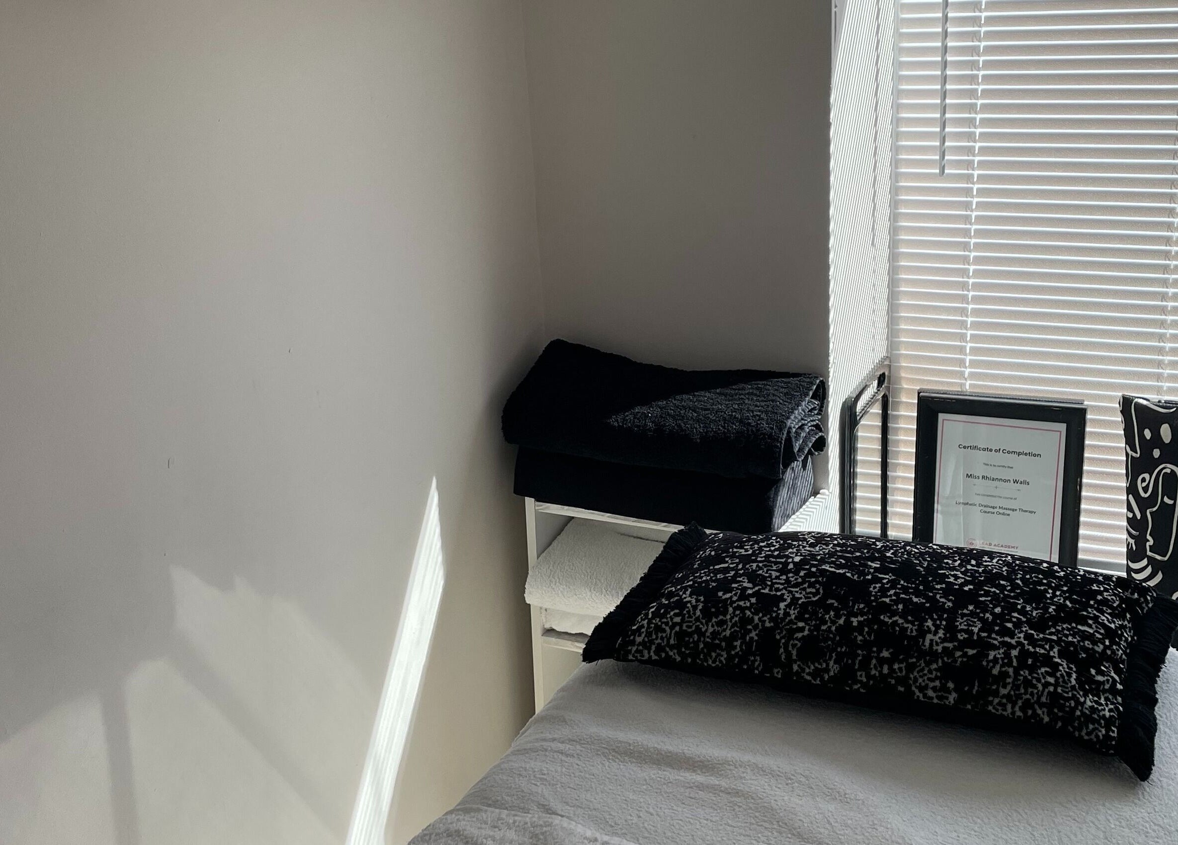 Tranquil therapy room at Recover with Dora, Cambridge, England, GB with a cozy bed and soothing decor.