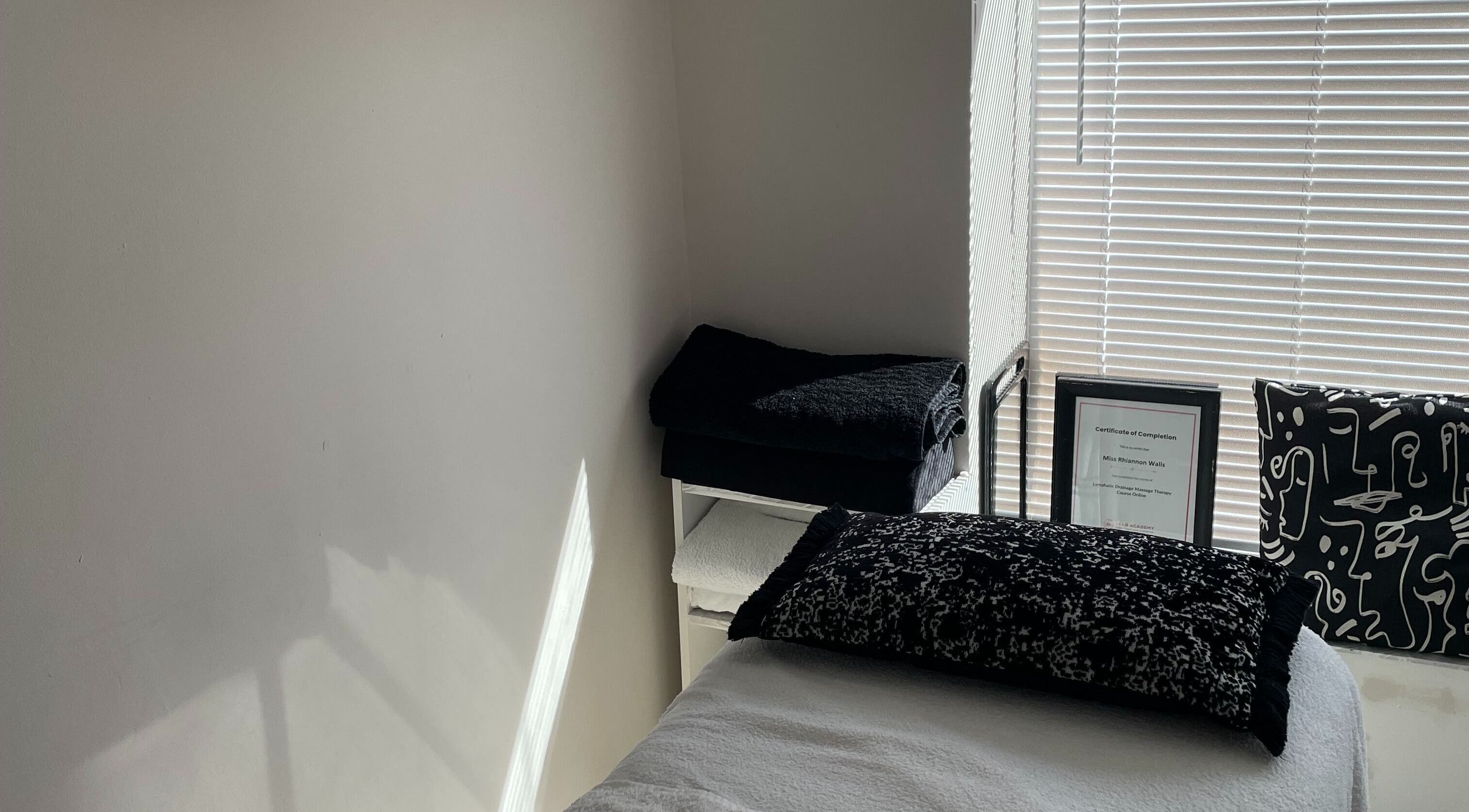 Tranquil therapy room at Recover with Dora, Cambridge, England, GB with a cozy bed and soothing decor.