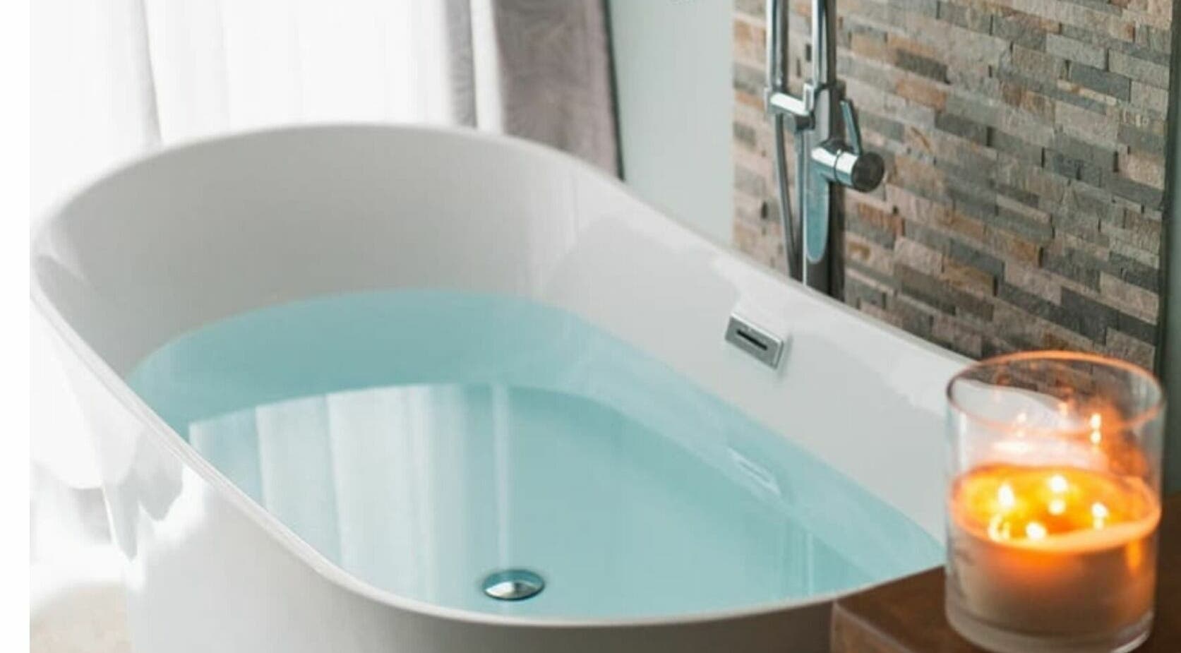 Luxurious bathtub at Reflections Spa Barbados in Bridgetown, Christ Church, BB, with relaxing candles.