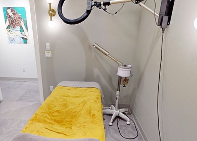Relaxing treatment room at The Loft, Canmore, Alberta, CA featuring a cozy yellow blanket and modern lighting.