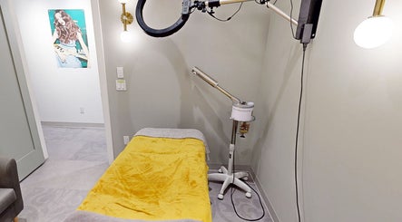 Relaxing treatment room at The Loft, Canmore, Alberta, CA featuring a cozy yellow blanket and modern lighting.