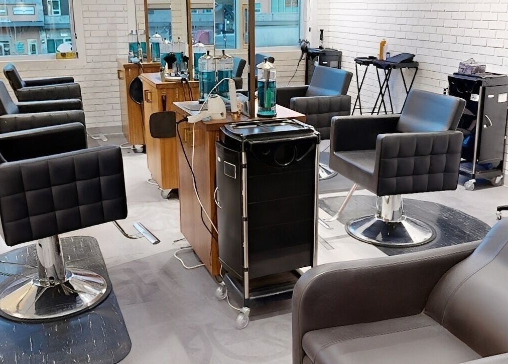Modern salon interior at The Loft in Canmore, Alberta, CA, featuring sleek styling chairs and mirrors.