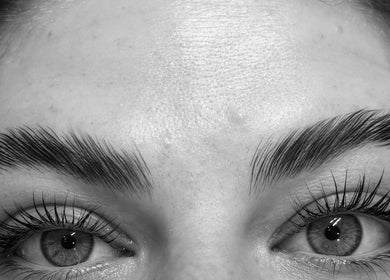 Close-up of perfectly shaped eyebrows and eyelashes by Tynaesthetics_ in London, England, GB.