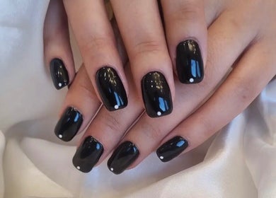 Stylish black manicure with white dots at Tynaesthetics_ in London, England, GB.