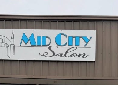 B. Hive Salon elegant signage at Huntsville, Alabama, US displaying sleek modern design.