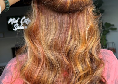 Vibrant wavy hairstyle at B. Hive Salon, Huntsville, Alabama, US, showcasing stunning color and shine.