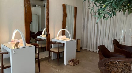 Elegant interior of Be.salon in Riyadh with stylish wooden mirrors and chic seating.