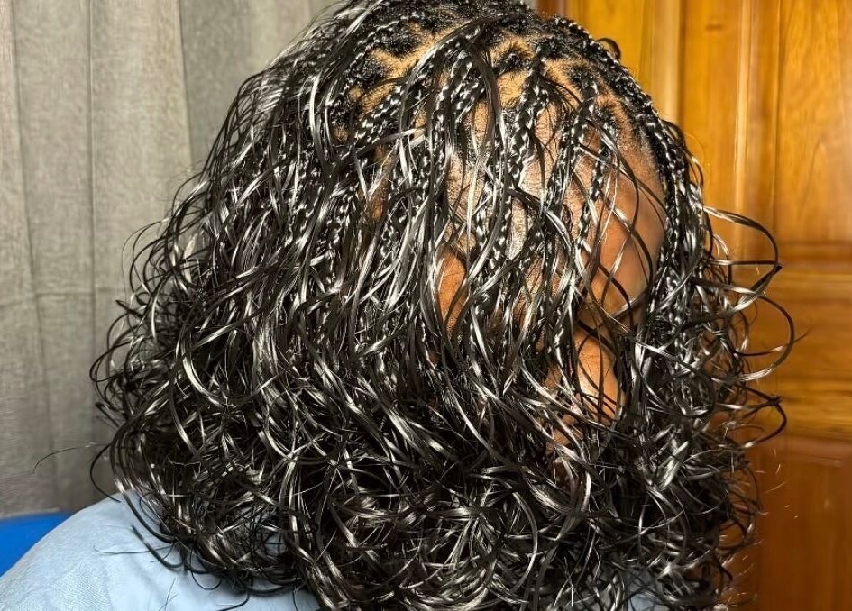 Elegant braided hairstyle with wavy finish at The Braids Lab in Tilbury, England, GB.