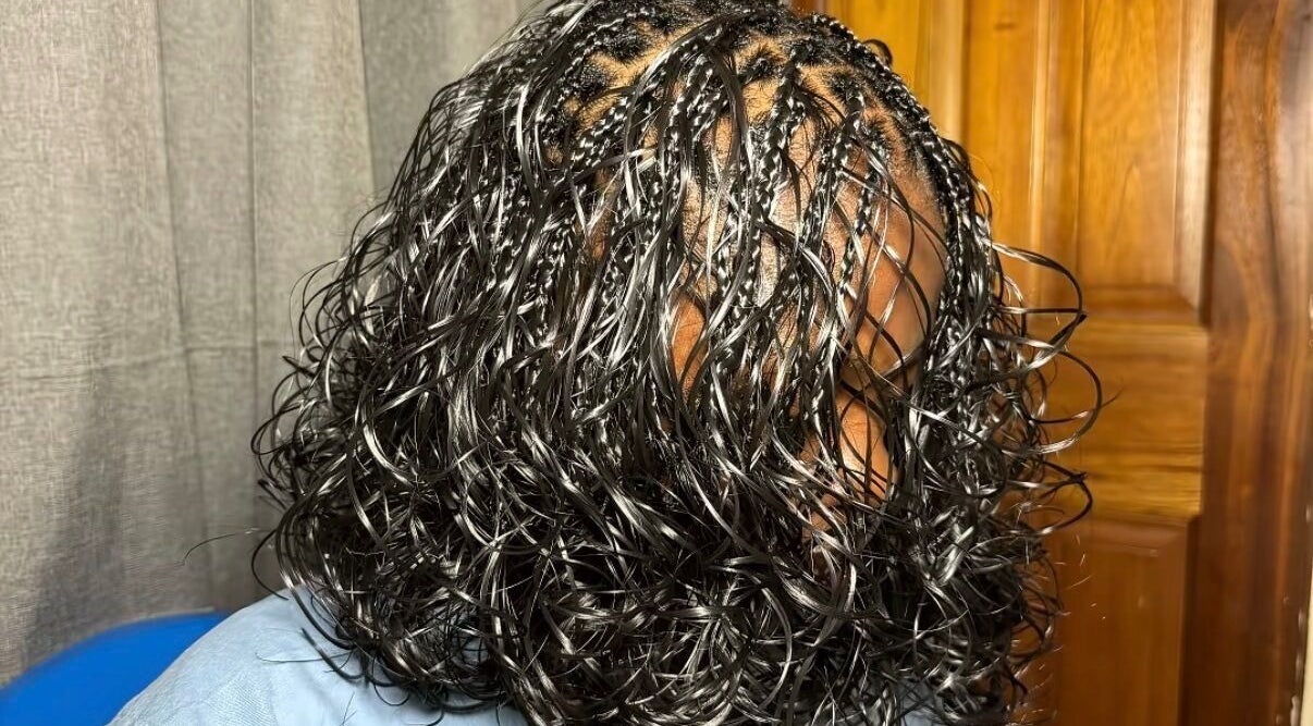 Elegant braided hairstyle with wavy finish at The Braids Lab in Tilbury, England, GB.