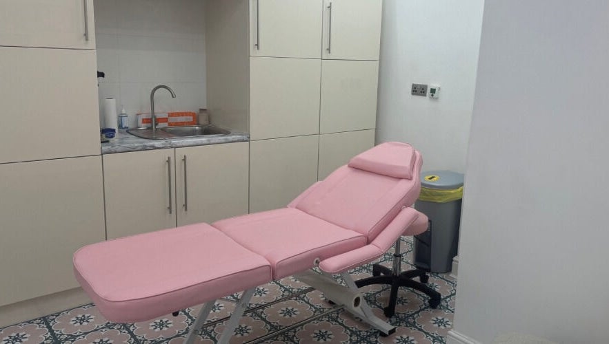 Cozy treatment room with pink massage bed at Angel Aesthetics, Stourbridge, England, GB.