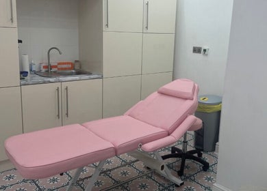 Cozy treatment room with pink massage bed at Angel Aesthetics, Stourbridge, England, GB.