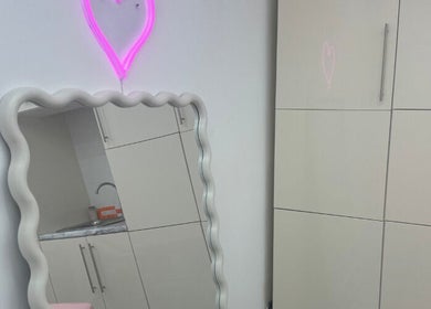 Neon heart decor and wavy mirror at Angel Aesthetics in Stourbridge, England, GB.