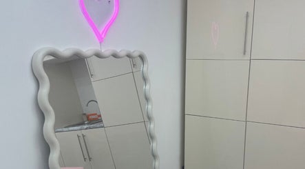 Neon heart decor and wavy mirror at Angel Aesthetics in Stourbridge, England, GB.