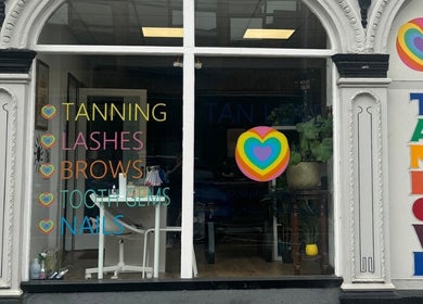 Colorful facade at Angel Aesthetics in Stourbridge, England, showcasing tanning, lashes, and more services.