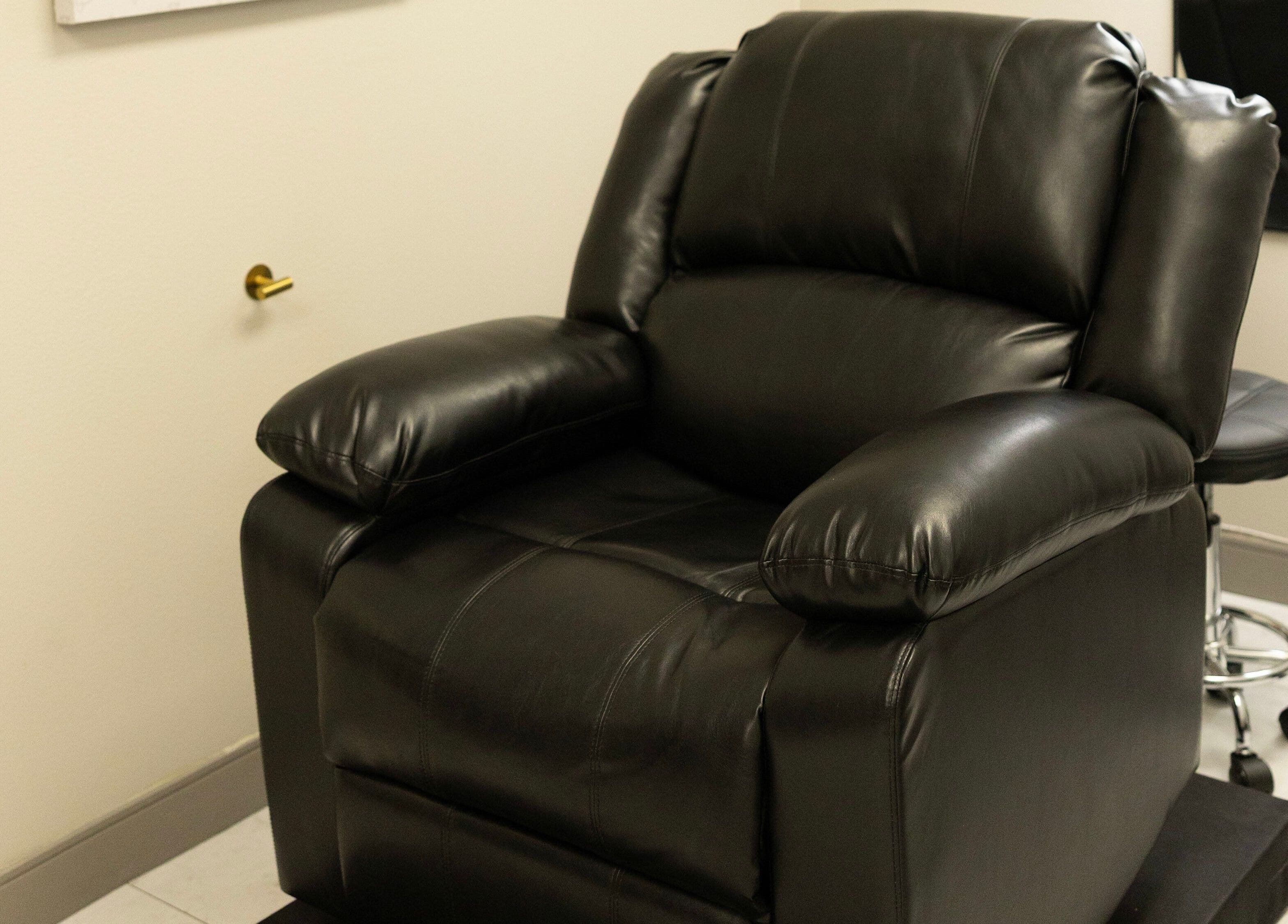 Luxury black leather chair at The LVSH Salon, Las Vegas, Nevada, US. Perfect for relaxation and treatments.