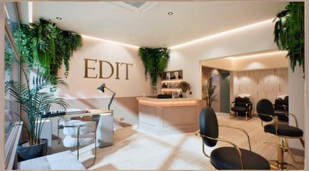 Interior of Hair by Stephanie Shaffi in Birmingham, England, GB. Modern decor with seating and lush greenery.