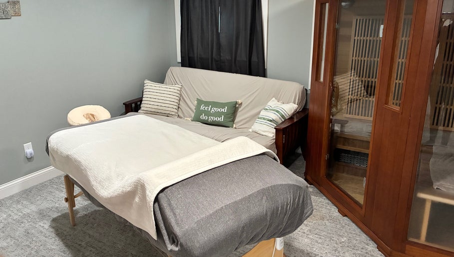 Relaxing treatment room at It Is Well, Burlington, Wisconsin, US, featuring massage bed and cozy decor.