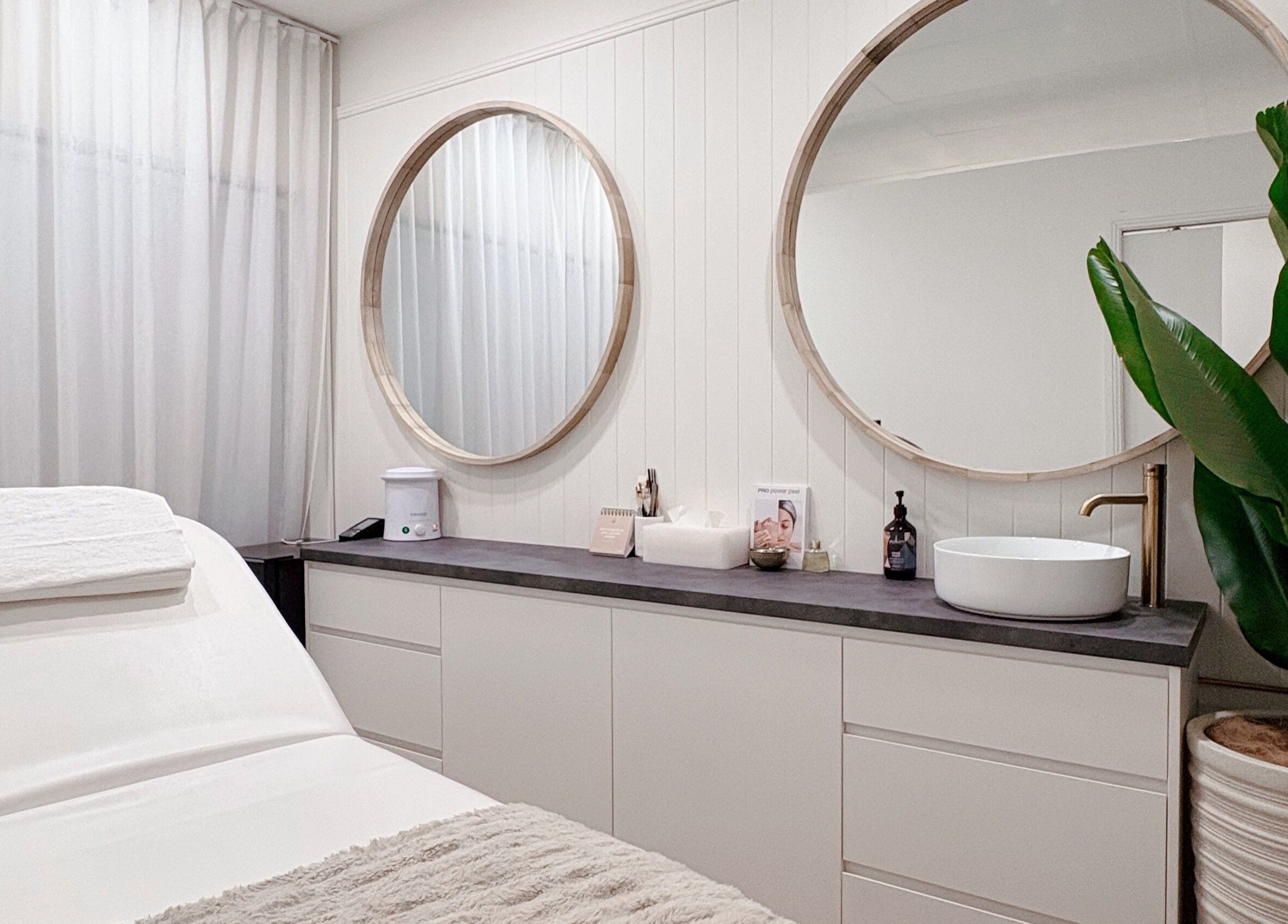 Elegant treatment room at Lashié, Burleigh Heads, Queensland, AU, featuring modern decor and cozy massage bed.