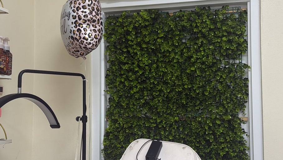 Relaxing setting at Kiss My Lash, Nassau, New Providence, BS, featuring lush greenery and stylish decor.
