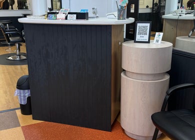 Reception area at Valeria’s Beauty Studio in Kennesaw, Georgia, US featuring sleek chair and counter.