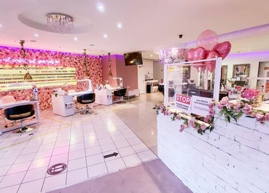 Elegant interior of The Nails Boutique in Kingston Upon Thames, England, GB with chic floral decor and modern stations.
