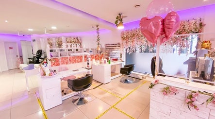 Chic interior of The Nails Boutique in Kingston Upon Thames, featuring floral decor and pink themed seating.