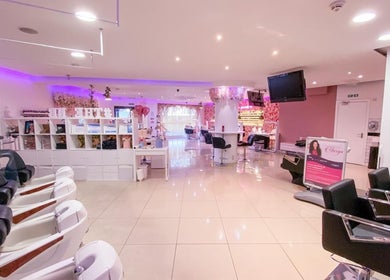 Spacious interior of The Nails Boutique, Kingston Upon Thames, England, GB, featuring modern salon chairs.
