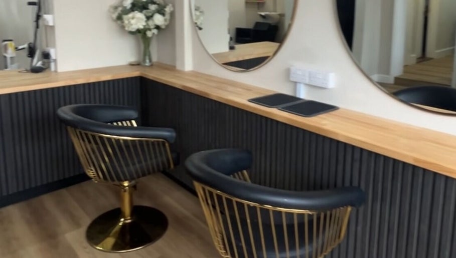 Elegant salon chairs at J c hairstylist, Stowmarket, England, GB with modern decor and sleek mirrors.