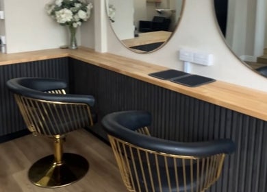 Elegant salon chairs at J c hairstylist, Stowmarket, England, GB with modern decor and sleek mirrors.