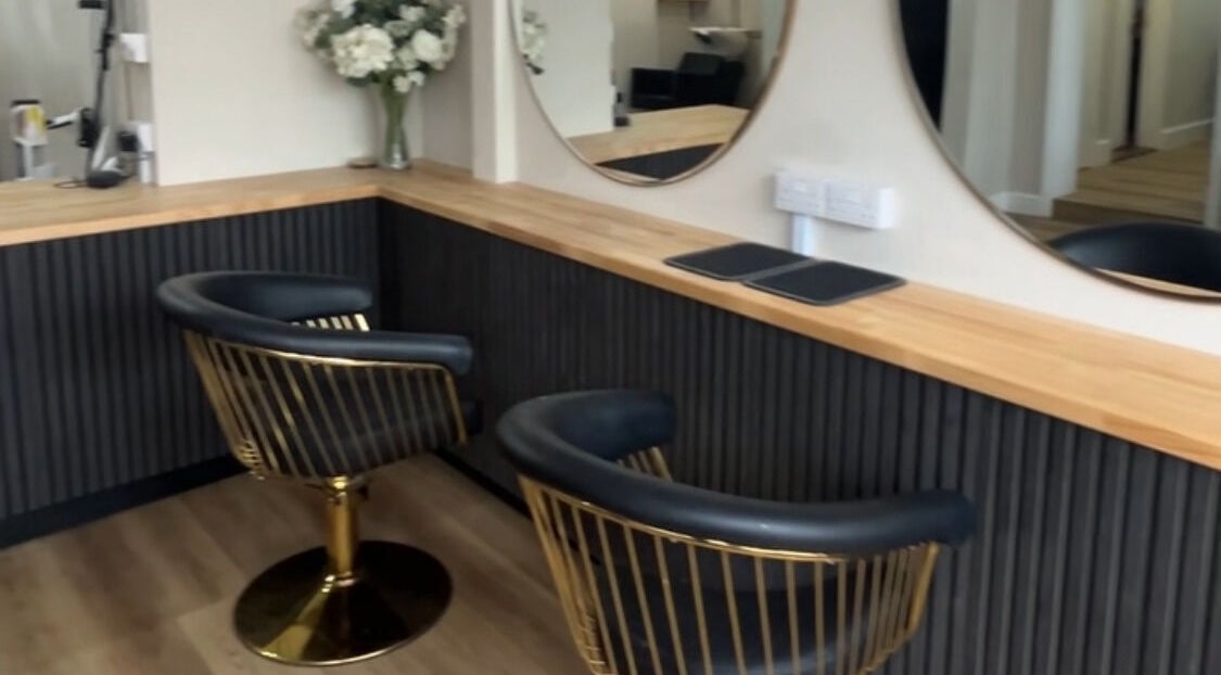 Elegant salon chairs at J c hairstylist, Stowmarket, England, GB with modern decor and sleek mirrors.
