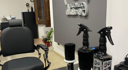 Interno di Taglio Geniale a Parenti, Calabria, IT, mostrando poltrona da barbiere e strumenti professionali.