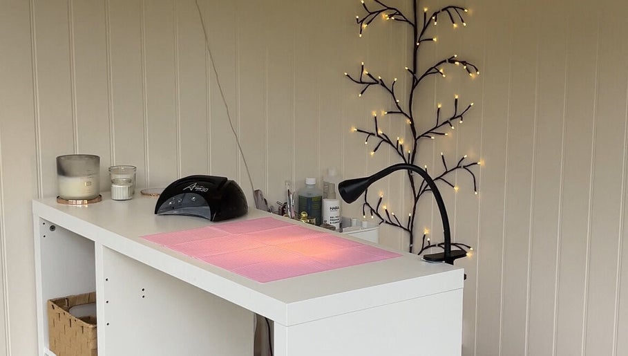 Nails By Gracie in Swindon, England, GB features a tidy nail station with a lamp and cozy decor.