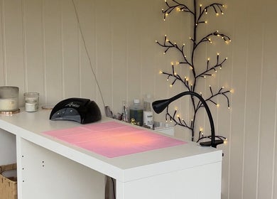 Nails By Gracie in Swindon, England, GB features a tidy nail station with a lamp and cozy decor.