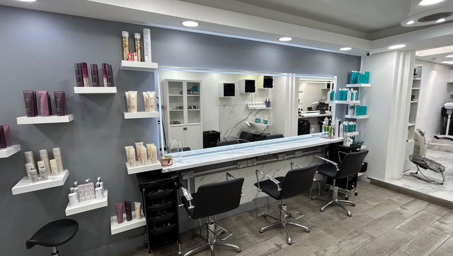 Elegant styling area in The Royal salon, London, England, GB with modern chairs and hair products.