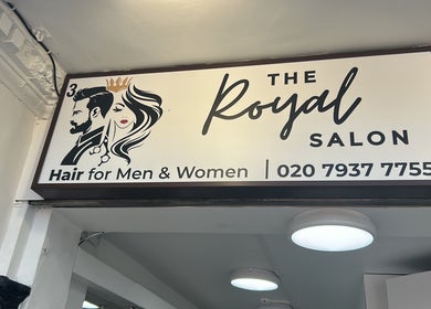 The Royal Salon sign in London, England, GB, offering hair services for men and women with contact details.