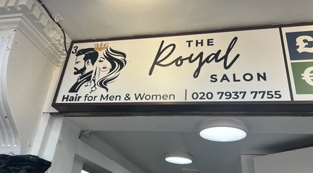 The Royal Salon sign in London, England, GB, offering hair services for men and women with contact details.
