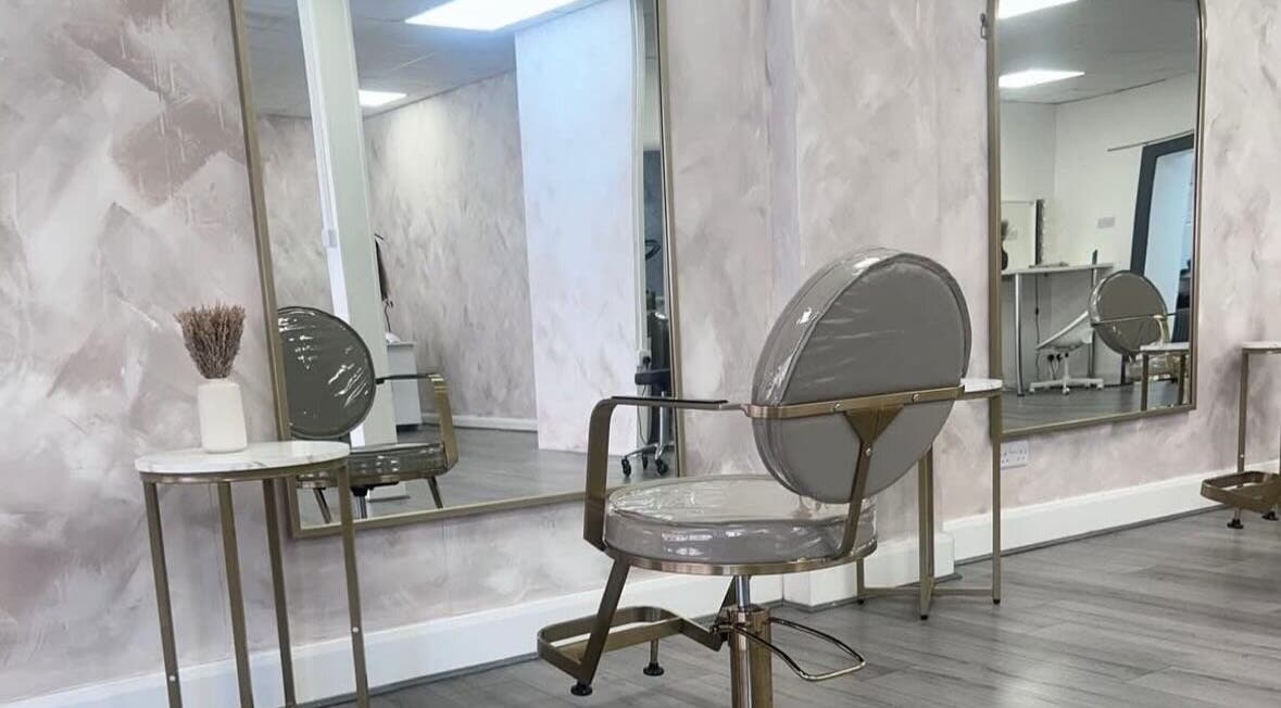 Modern hair salon interior at LuxeLocksBySeren in Connah's Quay, Wales, GB, featuring chic chairs and mirrors.