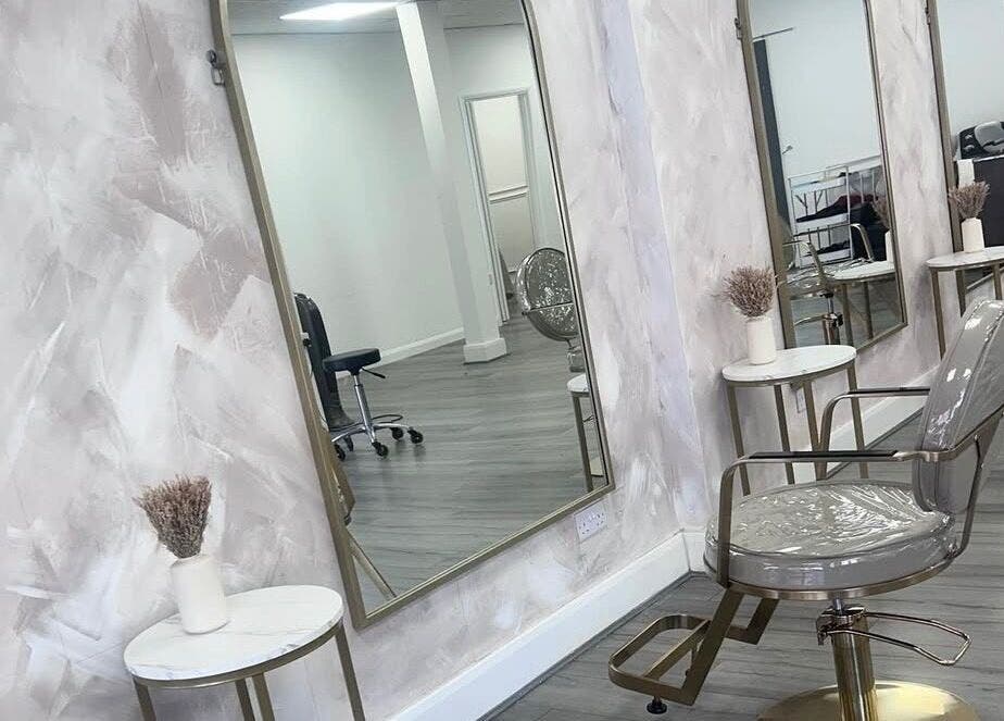 Chic salon interior at LuxeLocksBySeren in Connah's Quay, Wales, GB, featuring stylish mirrors and seating.