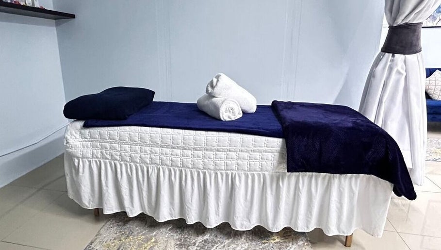 Cozy treatment bed at Natural24 Beauty Studio, Randburg, Gauteng, ZA, offering serene spa services.