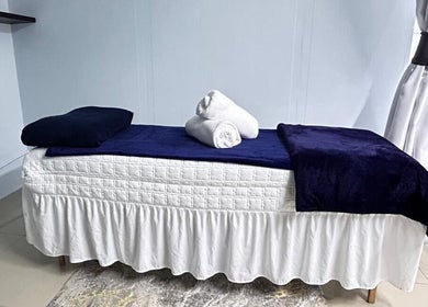 Cozy treatment bed at Natural24 Beauty Studio, Randburg, Gauteng, ZA, offering serene spa services.