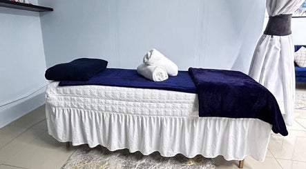 Cozy treatment bed at Natural24 Beauty Studio, Randburg, Gauteng, ZA, offering serene spa services.