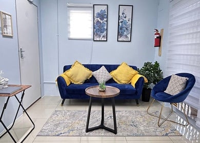 Elegant seating area at Natural24 Beauty Studio, Randburg, Gauteng, ZA with blue chairs and decor.