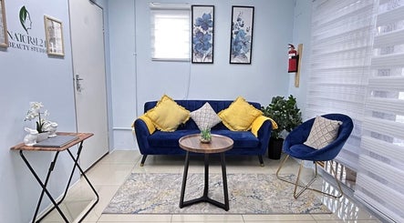 Elegant seating area at Natural24 Beauty Studio, Randburg, Gauteng, ZA with blue chairs and decor.