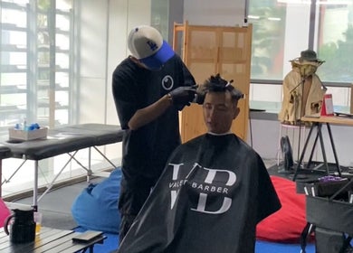 Stylist at The Valet Barber providing a haircut in Ampang, Selangor, MY.