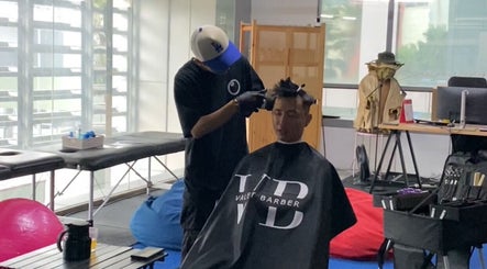 Stylist at The Valet Barber providing a haircut in Ampang, Selangor, MY.