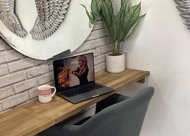 Stylish workspace at Hair by Janine at Shelley Lane Salon, Aberkenfig, Wales, GB featuring plant decor and laptop.