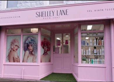 Exterior of Hair by Janine at Shelley Lane Salon, Aberkenfig, Wales, GB, showcasing stylish window displays.