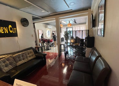 Interior view of Fade’N Cut Barber Shop in Paranaque City, Metro Manila, PH, featuring modern seating and decor.