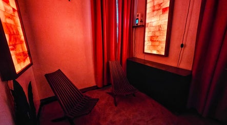 Relaxing salt room at Centered Wellness Clinic and Spa, Wentzville, Missouri, US with soothing red lighting.