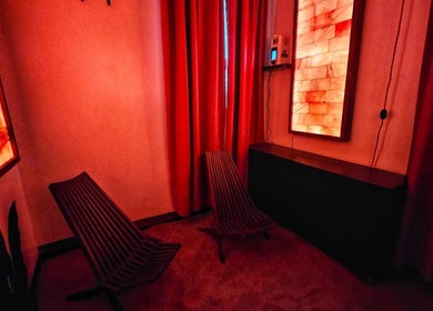 Tranquil salt room at Centered Wellness Clinic and Spa, Wentzville, Missouri, US, with warm lighting and chairs.